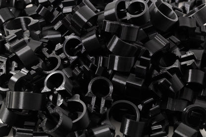 Pile of black metal washers and nuts