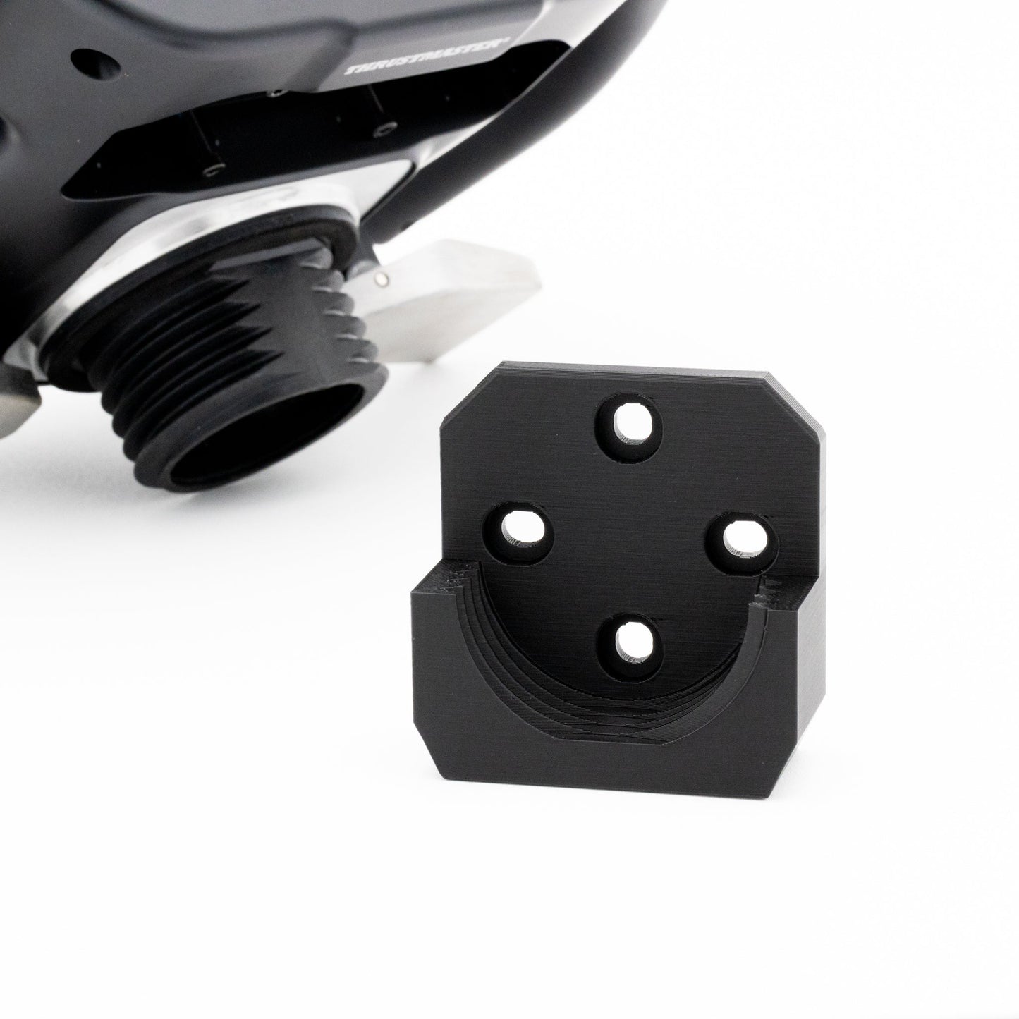 Black metal bracket with three holes on a white background