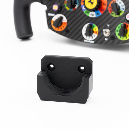 Black metal bracket on a white background with a colorful device in the background