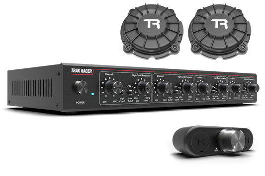 Trak Racer amplifier and speakers on a white background