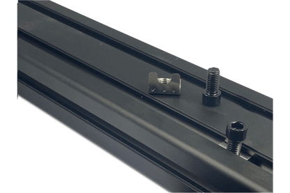 Metal track with mounting hardware on a black background