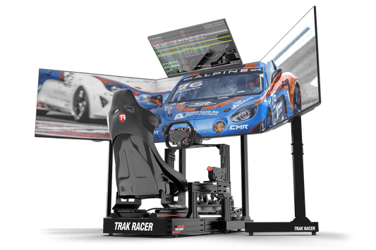 Racing simulator setup with a chair, steering wheel, and multiple screens displaying racing game.