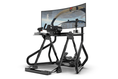 Simulator setup with a monitor displaying a flight simulation game on a green background