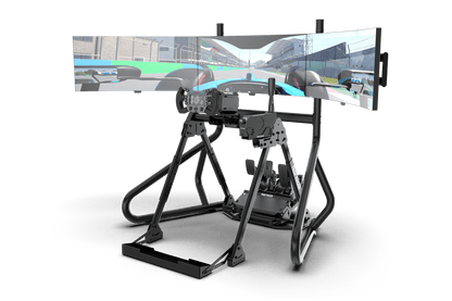 Virtual reality simulation setup with three monitors displaying a racing game.