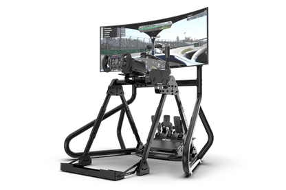 Virtual reality setup with a monitor displaying a racing game on a stand.