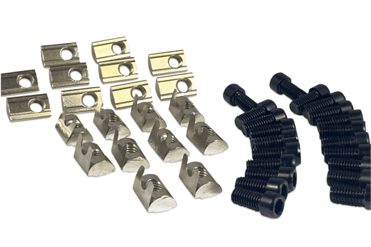 Metal clips and black rubber grommets on a black background