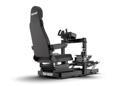 Black gaming simulator chair with 'Trak Racer' branding on a white background