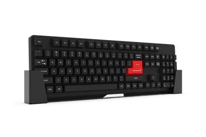 Black mechanical keyboard with a red escape key on a white platform against a black background